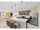 Open concept kitchen featuring stainless steel appliances, white countertops, and an island with seating at 11328 Blue Bay Dr, Orlando, FL 32832