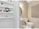 Chic powder room with modern fixtures, floating shelves, and contemporary decor at 11328 Blue Bay Dr, Orlando, FL 32832