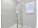 Tiled stand up shower with glass doors and a nearby window at 11328 Blue Bay Dr, Orlando, FL 32832