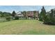 Large, grassy backyard with lush landscaping around the home, chain link fence, and room to roam at 11994 Mckinnon Rd, Windermere, FL 34786