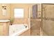 Spa-like bathroom featuring a jacuzzi tub and a glass enclosed walk in shower at 11994 Mckinnon Rd, Windermere, FL 34786