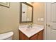 Powder room featuring a single sink vanity, tile flooring, and neutral paint at 11994 Mckinnon Rd, Windermere, FL 34786