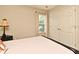 Bedroom featuring a double door closet, window, neutral colors, and a black nightstand at 11994 Mckinnon Rd, Windermere, FL 34786
