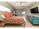 Bright bedroom with a ceiling fan, comfortable seating, and sliding glass doors to the outside at 11994 Mckinnon Rd, Windermere, FL 34786