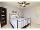 Comfortable bedroom featuring a black metal bed frame, ceiling fan, and a tiled floor at 11994 Mckinnon Rd, Windermere, FL 34786