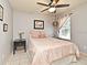 Bedroom featuring a ceiling fan, a window, a double door closet, and neutral paint at 11994 Mckinnon Rd, Windermere, FL 34786