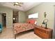Cozy bedroom featuring a tile floor, a ceiling fan, and a large window for natural light at 11994 Mckinnon Rd, Windermere, FL 34786