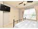 Bedroom with a ceiling fan, a large window with curtains, and a double closet at 11994 Mckinnon Rd, Windermere, FL 34786