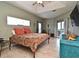 Bedroom with a ceiling fan, a cozy seating area, and views of the outside through sliding glass doors at 11994 Mckinnon Rd, Windermere, FL 34786