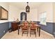 Charming dining room featuring a wooden table and chairs, complemented by elegant decor and natural light at 11994 Mckinnon Rd, Windermere, FL 34786