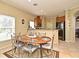 Eat-in kitchen features a dining table and a view of the kitchen with a breakfast bar at 11994 Mckinnon Rd, Windermere, FL 34786