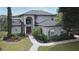 Charming two-story home with a well-manicured lawn and inviting front entrance at 11994 Mckinnon Rd, Windermere, FL 34786