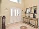 Bright foyer featuring tile floors, console table and decorative mirrors at 11994 Mckinnon Rd, Windermere, FL 34786