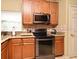 Kitchen featuring stainless steel appliances, granite countertops, and wood cabinets at 11994 Mckinnon Rd, Windermere, FL 34786