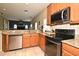 Kitchen featuring stainless steel appliances, granite countertops, and wood cabinets at 11994 Mckinnon Rd, Windermere, FL 34786