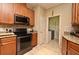 Kitchen featuring stainless steel appliances, granite countertops, and wood cabinets at 11994 Mckinnon Rd, Windermere, FL 34786