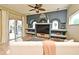 Cozy living room with built-in shelving, neutral color palette, and access to the pool area at 11994 Mckinnon Rd, Windermere, FL 34786
