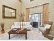 Cozy living room with neutral-toned furniture and a sliding glass door to the outside at 11994 Mckinnon Rd, Windermere, FL 34786