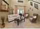 Elegant living room with high ceilings, a large mirror, and comfortable seating around a coffee table at 11994 Mckinnon Rd, Windermere, FL 34786