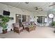 Covered patio with comfortable seating and string lights for a relaxing outdoor space at 11994 Mckinnon Rd, Windermere, FL 34786