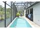 Outdoor pool area with pool toys in the water, screened-in lanai, and privacy fence at 11994 Mckinnon Rd, Windermere, FL 34786