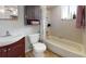 Cozy bathroom with tiled walls, tub/shower, and dark wood vanity at 12381 Antonio Cir, Orlando, FL 32826