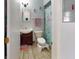 A cozy bathroom featuring a wood floor, vanity with sink and bath with shower at 12381 Antonio Cir, Orlando, FL 32826