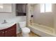 Cozy bathroom with tiled walls, tub/shower, and dark wood vanity at 12381 Antonio Cir, Orlando, FL 32826