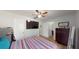 Bedroom with a view into the bathroom, featuring wood-look floors and a striped comforter at 12381 Antonio Cir, Orlando, FL 32826