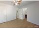 Bright bedroom featuring light wood floors and a bathroom with dark vanity at 12381 Antonio Cir, Orlando, FL 32826