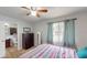 Bedroom with natural light and wood-look flooring, leading into the bathroom at 12381 Antonio Cir, Orlando, FL 32826
