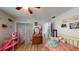 Cheerful bedroom with a pink daybed and a view into the bathroom at 12381 Antonio Cir, Orlando, FL 32826