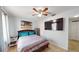 Bedroom featuring a ceiling fan, wood-look floors, and a large TV at 12381 Antonio Cir, Orlando, FL 32826