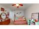 Bright bedroom with light walls, a ceiling fan, and a pink daybed at 12381 Antonio Cir, Orlando, FL 32826