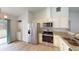 Bright kitchen features modern, stainless steel appliances, tile floors and light-toned cabinetry at 12381 Antonio Cir, Orlando, FL 32826