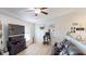Cozy living room with wood-look flooring, ceiling fan, and lots of natural light at 12381 Antonio Cir, Orlando, FL 32826