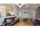 Living room with wood-look floors, lots of decorations and an open layout to kitchen at 12381 Antonio Cir, Orlando, FL 32826