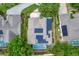 Aerial view of a single Gathering home with a large backyard pool and solar panels on the roof at 12411 Scarlett Sage Ct, Winter Garden, FL 34787