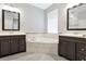 Bright bathroom with a corner soaking tub, double vanity and tile floor at 12411 Scarlett Sage Ct, Winter Garden, FL 34787