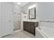 Bright bathroom with a walk in shower, soaking tub, vanity and tiled floor at 12411 Scarlett Sage Ct, Winter Garden, FL 34787