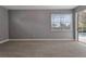 Neutral colored bedroom with carpeted floor and a sliding glass door to access to pool area at 12411 Scarlett Sage Ct, Winter Garden, FL 34787