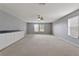 Bonus room with cabinets, neutral carpet, and windows at 12411 Scarlett Sage Ct, Winter Garden, FL 34787