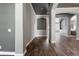 Elegant hallway featuring hardwood floors, gray walls, and decorative archways, creating a sophisticated transition between rooms at 12411 Scarlett Sage Ct, Winter Garden, FL 34787