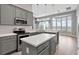 Bright kitchen with gray cabinets, stainless steel appliances, an island, and views from the breakfast nook at 12411 Scarlett Sage Ct, Winter Garden, FL 34787