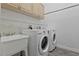 Laundry room with a washer, dryer, sink, and cabinets at 12411 Scarlett Sage Ct, Winter Garden, FL 34787