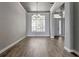 Bright living room with hardwood floors, large window, and modern lighting, creating an inviting and spacious atmosphere at 12411 Scarlett Sage Ct, Winter Garden, FL 34787