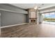 Bright living room featuring a modern fireplace, hardwood floors, and natural light at 12411 Scarlett Sage Ct, Winter Garden, FL 34787