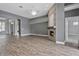 Open living space showcasing a stone fireplace, hardwood floors, and views to the front entry at 12411 Scarlett Sage Ct, Winter Garden, FL 34787