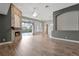 Open-concept living area featuring a stone fireplace, high ceilings, and hardwood floors at 12411 Scarlett Sage Ct, Winter Garden, FL 34787