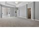 Spacious main bedroom with neutral carpet, ceiling fan and access to bathroom and patio at 12411 Scarlett Sage Ct, Winter Garden, FL 34787